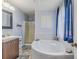 Bright bathroom featuring a soaking tub, shower, and vanity, creating a serene atmosphere at 252 Parkway Ct, Dallas, GA 30157