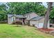 Charming home with a well-maintained front yard, beautiful tree, and inviting front porch at 252 Parkway Ct, Dallas, GA 30157