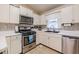 Bright kitchen featuring white cabinets, stainless steel appliances, and a gas range at 252 Parkway Ct, Dallas, GA 30157