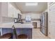 Well-lit kitchen with white cabinets, stainless steel appliances, and tile backsplash at 252 Parkway Ct, Dallas, GA 30157