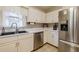 A well-organized kitchen with stainless steel appliances, white cabinetry, and a sink beneath a window at 252 Parkway Ct, Dallas, GA 30157