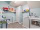 Spacious laundry room with ample shelving, new washer and dryer and light blue walls at 252 Parkway Ct, Dallas, GA 30157