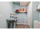 Bright laundry room with an ironing table, animal art and ample shelving at 252 Parkway Ct, Dallas, GA 30157