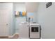 Bright laundry room featuring a washer and dryer with light blue walls at 252 Parkway Ct, Dallas, GA 30157