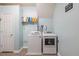Bright laundry room featuring a washer and dryer with light blue walls at 252 Parkway Ct, Dallas, GA 30157