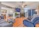 Inviting living room with fireplace, wood floors, and cozy seating area adjacent to a dining area at 252 Parkway Ct, Dallas, GA 30157
