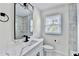 Stylish bathroom remodel with marble-look tile, black fixtures, and modern vanity with quartz countertop at 2502 Tupelo Se St, Atlanta, GA 30317