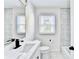 Remodeled bathroom showcasing quartz countertop, black fixtures, and gorgeous marble-look tile surround at 2502 Tupelo Se St, Atlanta, GA 30317