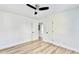 Bright bedroom features a ceiling fan, fresh white paint, and modern light wood floors at 2502 Tupelo Se St, Atlanta, GA 30317