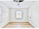 Bright bedroom features light hardwood floors, a ceiling fan, and fresh white paint at 2502 Tupelo Se St, Atlanta, GA 30317