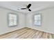 Bright bedroom featuring new floors, base trim, ceiling fan, and two windows for natural light at 2502 Tupelo Se St, Atlanta, GA 30317