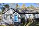Charming single-story home with white brick, black trim, and a bright blue door at 2502 Tupelo Se St, Atlanta, GA 30317