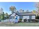 Charming single-story home with white brick, black trim, a bright blue door, and accessible ramp at 2502 Tupelo Se St, Atlanta, GA 30317