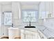 Updated kitchen with white cabinets, marble countertops, subway tile backsplash, and new appliances at 2502 Tupelo Se St, Atlanta, GA 30317