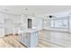 Inviting kitchen with gray island, modern pendant lights, stainless hardware, and wood-look floors at 2502 Tupelo Se St, Atlanta, GA 30317
