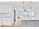 Open kitchen with island and marble countertops that connects to bright airy living area at 2502 Tupelo Se St, Atlanta, GA 30317