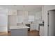 Bright kitchen featuring white cabinets, quartz counters, stainless appliances, and an island at 2502 Tupelo Se St, Atlanta, GA 30317