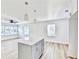 Modern kitchen with gray island, white cabinets, modern pendant lights, and stainless steel appliances at 2502 Tupelo Se St, Atlanta, GA 30317