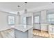 Bright, open kitchen featuring a central island, modern pendant lights, and white cabinetry at 2502 Tupelo Se St, Atlanta, GA 30317
