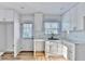 Bright kitchen features white cabinets, marble countertops, subway tile backsplash, and modern fixtures at 2502 Tupelo Se St, Atlanta, GA 30317