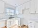 Newly renovated kitchen with white cabinets, marble counters, subway tile, and stainless steel appliances at 2502 Tupelo Se St, Atlanta, GA 30317