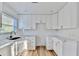 Bright kitchen boasts white cabinetry, sleek hardware, marble countertops, and bright natural light at 2502 Tupelo Se St, Atlanta, GA 30317