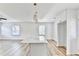 Open kitchen featuring a stylish island with quartz countertop, modern lighting, and bright white cabinetry at 2502 Tupelo Se St, Atlanta, GA 30317