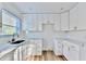 Modern kitchen boasts white cabinetry, sleek hardware, marble countertops, and bright natural light at 2502 Tupelo Se St, Atlanta, GA 30317