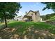View of backyard from grassy area, showcasing well-maintained lawn and surrounding trees at 31 Thunderhawk Ne Ln, Rydal, GA 30171