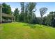 Expansive green backyard with a covered patio, perfect for outdoor activities at 31 Thunderhawk Ne Ln, Rydal, GA 30171