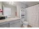 Bathroom with a sink and mirror plus a shower/tub with a white curtain at 31 Thunderhawk Ne Ln, Rydal, GA 30171