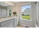 Bathroom featuring a double sink vanity, and a large window overlooking a spacious yard at 31 Thunderhawk Ne Ln, Rydal, GA 30171