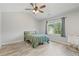 An airy bedroom with vaulted ceilings, a ceiling fan, and a window overlooking a yard at 31 Thunderhawk Ne Ln, Rydal, GA 30171