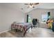 An airy bedroom with vaulted ceilings, a ceiling fan, and two windows overlooking a yard at 31 Thunderhawk Ne Ln, Rydal, GA 30171
