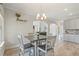 Dining area under chandelier with archway leading to living room and kitchen with granite countertops at 31 Thunderhawk Ne Ln, Rydal, GA 30171