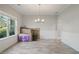 Dining room with a modern chandelier, a large window, and wood-look flooring at 31 Thunderhawk Ne Ln, Rydal, GA 30171