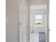 A hallway leads into a bathroom with a window, offering bright natural light at 31 Thunderhawk Ne Ln, Rydal, GA 30171
