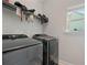 Laundry room with gray washer and dryer and storage shelves, offering convenience and organization at 31 Thunderhawk Ne Ln, Rydal, GA 30171
