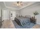 Comfortable main bedroom featuring tray ceiling, gray rug, wood floors and doorway leading to closet at 31 Thunderhawk Ne Ln, Rydal, GA 30171
