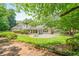 Spacious backyard with a patio, lush greenery, and a well-maintained lawn at 425 Greenmont Walk Ct, Alpharetta, GA 30009