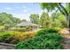 Lush backyard with mature trees, a fenced perimeter, and a view of the home's rear exterior at 425 Greenmont Walk Ct, Alpharetta, GA 30009