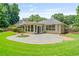 Inviting backyard with a stone patio, green lawn, and partial view of the home at 425 Greenmont Walk Ct, Alpharetta, GA 30009