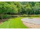 Serene backyard with a stone patio and lush landscaping, perfect for outdoor relaxation at 425 Greenmont Walk Ct, Alpharetta, GA 30009