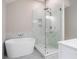 Luxurious bathroom showcasing a soaking tub, glass shower, and elegant marble finishes at 425 Greenmont Walk Ct, Alpharetta, GA 30009