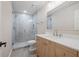 Bright bathroom featuring glass enclosed shower, wood vanity with a marble top at 425 Greenmont Walk Ct, Alpharetta, GA 30009