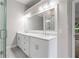 Bright bathroom features dual sink vanities, a large mirror, and tile flooring at 425 Greenmont Walk Ct, Alpharetta, GA 30009