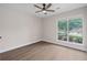 Cozy bedroom with fan, window and hardwood floors at 425 Greenmont Walk Ct, Alpharetta, GA 30009
