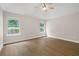Large bedroom featuring ceiling fan, windows and hardwood floors at 425 Greenmont Walk Ct, Alpharetta, GA 30009