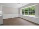 Bright dining room features hardwood floors, wainscoting and a large window with backyard view at 425 Greenmont Walk Ct, Alpharetta, GA 30009
