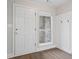 Welcoming entryway featuring a white door, window, and coat rack with bright, neutral paint at 425 Greenmont Walk Ct, Alpharetta, GA 30009